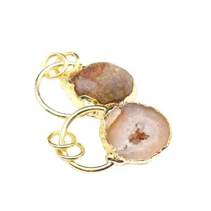 Natural agate geode thunder egg pendants with gold-plated edges on white background