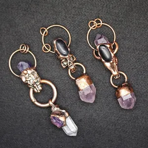 Gothic amethyst crystal pillar pendants with antique copper bull skull and leopard motifs.