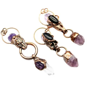 Exaggerated gothic animal skull pendants with amethyst and clear quartz crystal points