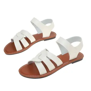 Stylish women's flat Roman sandals featuring white cross straps and a brown footbed detail