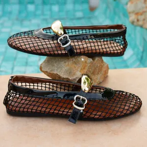 Close-up showing the intricate black fishnet mesh and golden buckle of these flat sandals