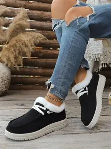 Detailed view of black winter loafers with cozy white faux fur lining and thick soles