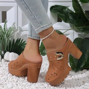 Side view of tan hollow-out chunky heel platform mule shoes with metal buckle detail