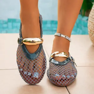 Detailed front view of women's grey hollow mesh sandals with large gold metal buckle