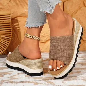 Vue détaillée de sandales compensées en toile marron avec une semelle plateforme espadrille