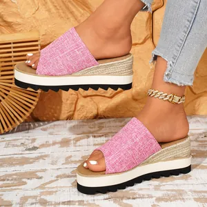 Détail de mules à plateforme en toile rose avec semelle compensée en corde tressée