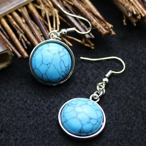 Elegant round blue turquoise stone dangle hook earrings with a polished silver finish