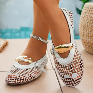 Detailed macro view of white mesh hollow-out flat shoes with a gold buckle and ankle strap