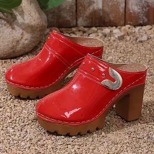 Red patent leather platform clogs with chunky high heels and metal rivet details
