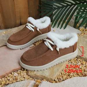 Detailed view of brown snow boots showing 3.3cm heel height and white faux fur lining.