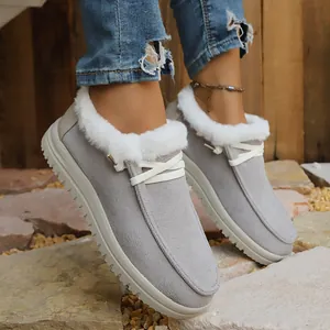 Grey fur-lined warm snow boots for women featuring flat white laces and thick textured soles