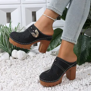 Side view of black cut-out chunky heel platform mule shoes with metal buckle detail