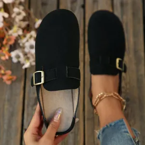 Stylish black suede-like closed-toe flat mules with adjustable gold buckle strap detail