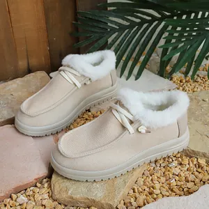 Cozy beige women's winter boots with thick white faux fur lining and lace-up detail.