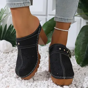 Close-up of black hollow-out chunky heel platform mules with metal buckle