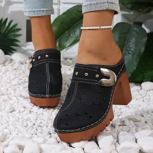 Black chunky heel clogs for women featuring hollow-out floral pattern and metal buckle