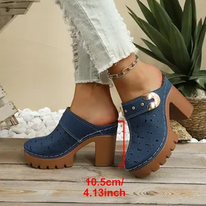 Close-up of blue chunky heel clogs featuring a 10.5cm platform and floral laser-cut upper