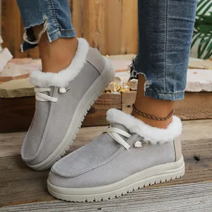 Grey winter loafers with white faux fur lining and lace-up detail on a model.