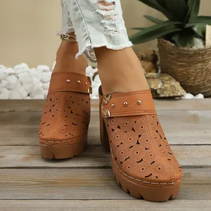Detailed view of brown laser-cut floral women's chunky heel mules with gold studs
