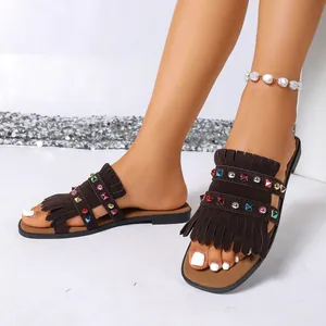Detailed view of brown fringe slippers with colorful rhinestone studs for women