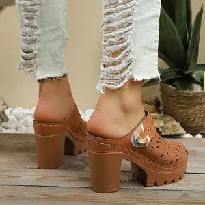 Side view of brown chunky heel platform mules with laser-cut floral pattern details