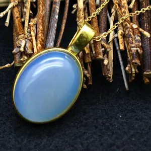 Elegant small blue agate pendant necklace with a 24k gold-plated oval frame design