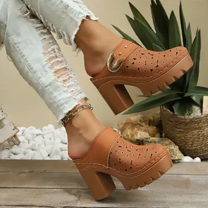 Detail view of tan platform mules with floral cutouts and chunky high heels on model.