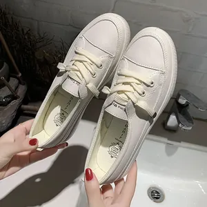 Close-up detail of white platform sneakers with textured leather finish for women