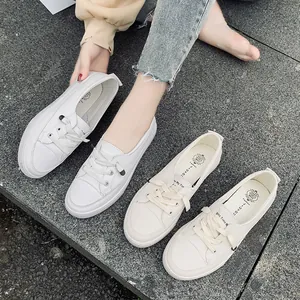 Minimalist white casual sneakers for women on stone background, daily lifestyle view