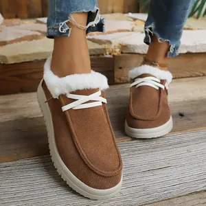 Women's brown warm fur-lined snow boots with white laces and flat soles for winter