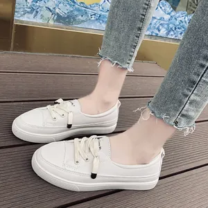 Close-up detail of white minimalist platform sneakers with textured leather finish