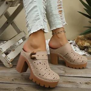 Detail of beige chunky heel mules with laser-cut floral patterns and platform sole