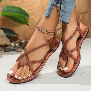 Detail of brown braided thong flat sandals for women featuring an elastic back strap.