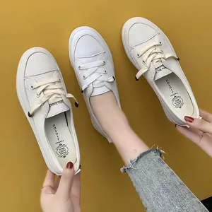 Minimalist white leather lace-up sneakers for women with flat rubber sole design