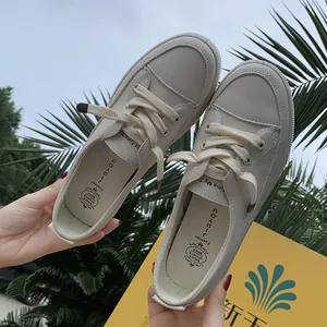 Close-up of off-white casual women's board shoes with lace-up detail and soft texture