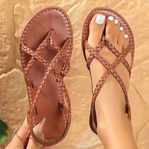 Close-up of brown braided strap thong sandals with elastic heel and round toe design