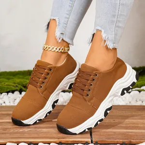 Brown thick-sole women's sneakers lace-up casual sports shoes on model feet view