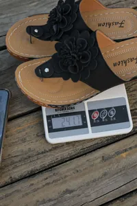 Detailed image showing the 241.7g weight of these floral wedge sandals on a scale.