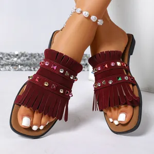 Stylish burgundy flat fringe sandals for women with colorful rhinestone studded straps.