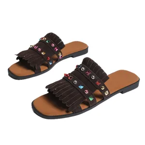 Brown flat sandals for women featuring stylish tassels and colorful rhinestone studs