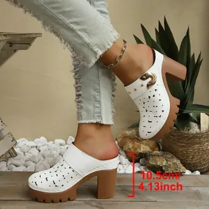 Detailed view of white laser-cut platform mule sandals with 10.5cm chunky heels.