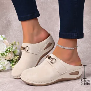 Stylish beige women's wedge mules featuring a 5.5cm heel and elegant gold chain link