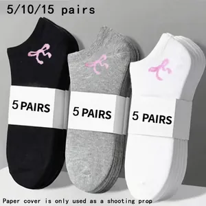 Close-up of men's sports ankle socks in black, grey, and white with ribbon embroidery.