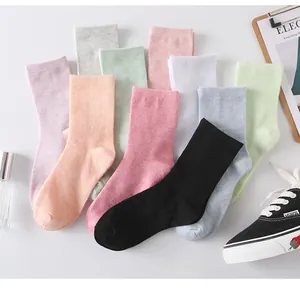 Detailed macro view showing a collection of candy-colored cotton socks in vibrant pastel shades