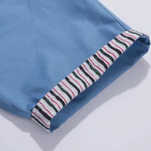 Detail shot of men's washed cotton shorts featuring a stylish striped cuffed hem design