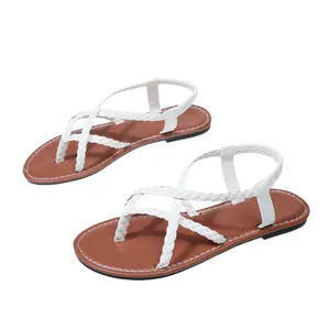 Women's flat sandals with braided white straps and elastic back strap on brown footbed
