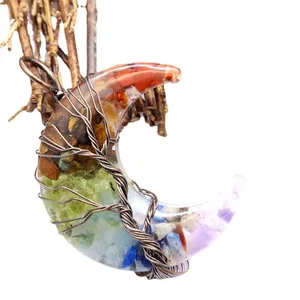 Exquisite wire wrapped moon pendant necklace featuring tree of life and chakra crystals.