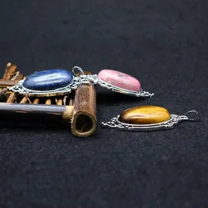 Three vintage oval gemstone pendants featuring lapis lazuli and tiger eye stones