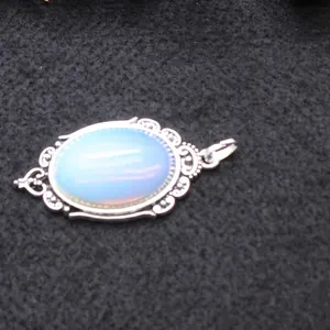 Vintage oval opal stone pendant necklace featuring an ornate silver filigree frame for women