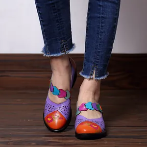 Close-up view of vintage macaron floral Mary Jane shoes on wooden floor
